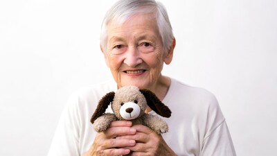Elderly woman holding stuffed dog