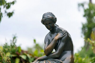 Bronze statue of seated woman