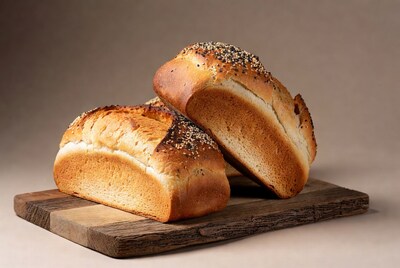 Two loaves of bread on wooden board