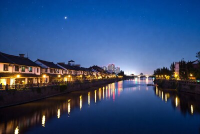 Night river with traditional buildings