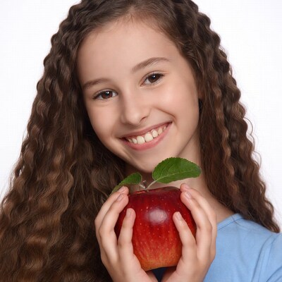Girl holding red apple