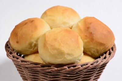 Golden dinner rolls in basket