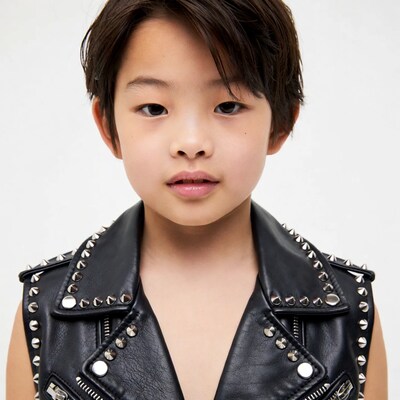 Asian boy in studded leather vest