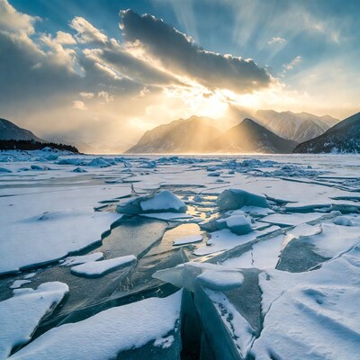 Frozen lake with ice chunks at sunset