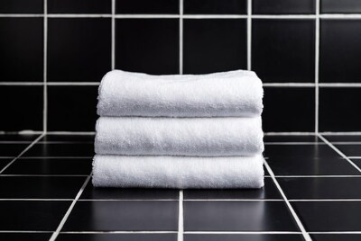 White towels stacked on black tiles