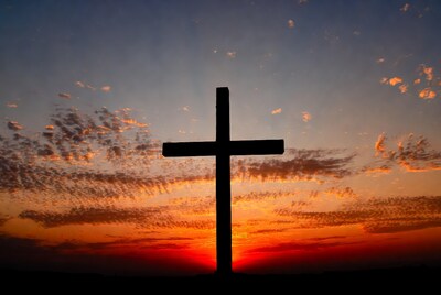 Silhouette of cross at sunset