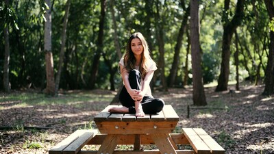 Young woman sitting on picnic table