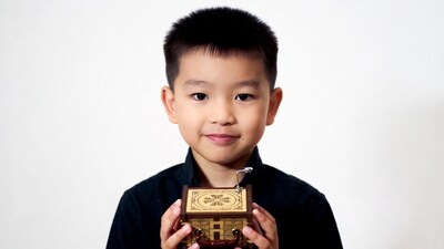 Asian boy holding music box