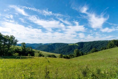Green hills under blue sky
