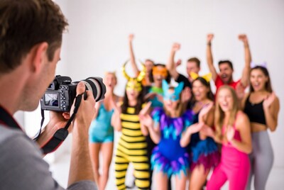 Photographer taking group photo of costumed people