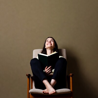 Woman reading book in chair