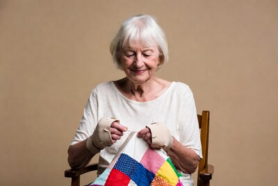 Elderly woman sewing a quilt