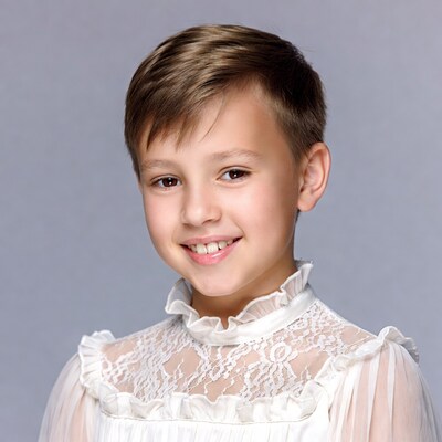 Young boy in white lace shirt