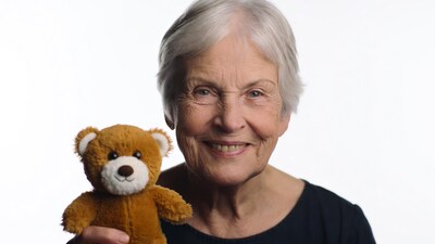 Elderly woman holding teddy bear
