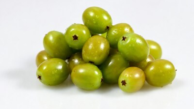Fresh green gooseberries on white background