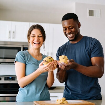 Couple holding cookie dough