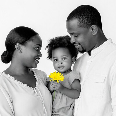 Family holding yellow flower