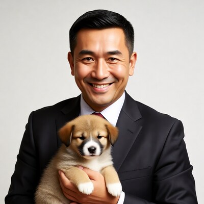 Asian man holding cute puppy