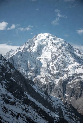Snowy mountain peak under blue sky