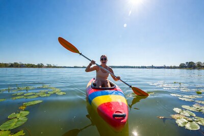 Woman kayaking on sunny lake