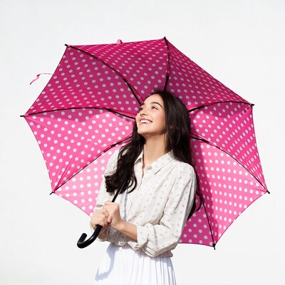 Woman holding pink polka dot umbrella