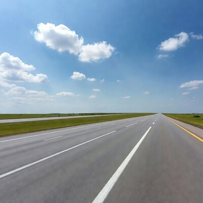 Empty highway under blue sky