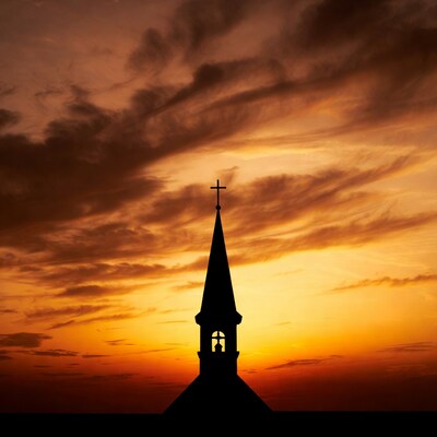 Church steeple silhouette at sunset