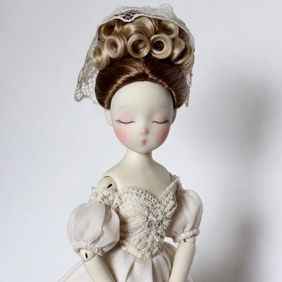 Doll with blonde updo hairstyle
