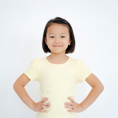 Young Asian girl smiling with hands on hips