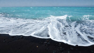Ocean waves on black sand beach