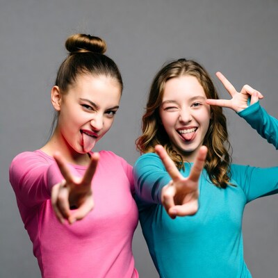 Two girls making peace signs