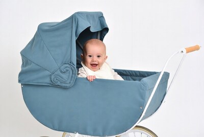 Baby in blue vintage stroller