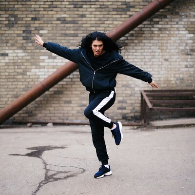 Woman Dancing in Black Tracksuit