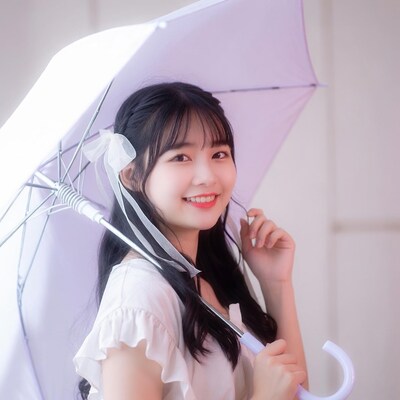 Smiling Asian girl with purple umbrella