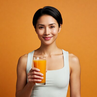 Asian woman holding orange juice