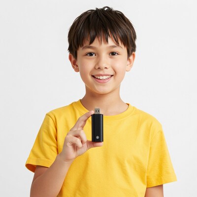 Smiling boy holding black USB flash drive
