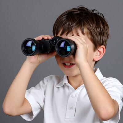 Boy looking through binoculars