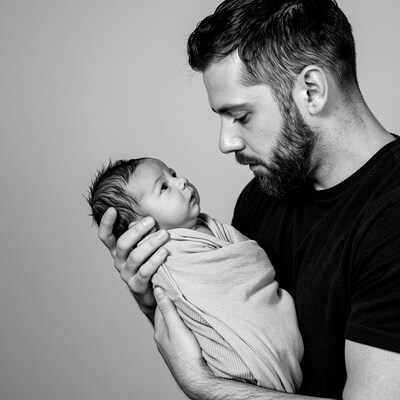 Father Holding Newborn Baby