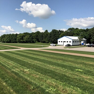 Mowed Grass Field with White Building