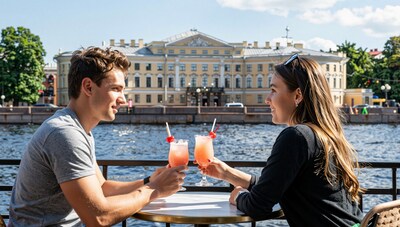 Couple toasting cocktails by river