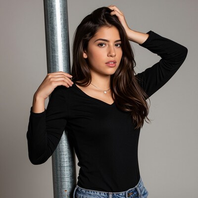 Young woman leaning on metal pole