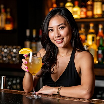 Asian woman with cocktail at bar