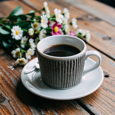Coffee Cup with Cozy on Wooden Table