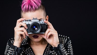 Punk Woman with Pink Mohawk Holding Camera