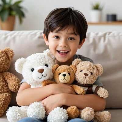 Smiling boy hugging teddy bears