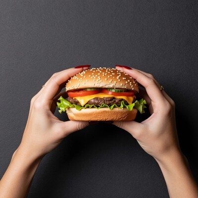 Hands holding cheeseburger