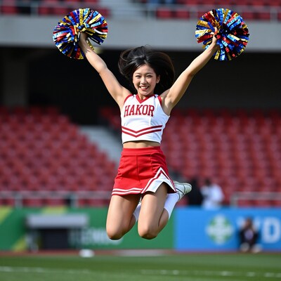 Asian Cheerleader Jumping with Pom Poms