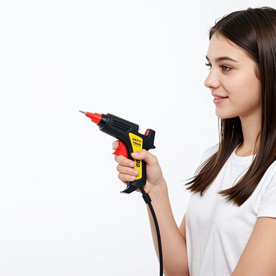 Woman holding hot glue gun