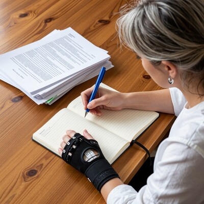 Woman writing in notebook with wrist brace