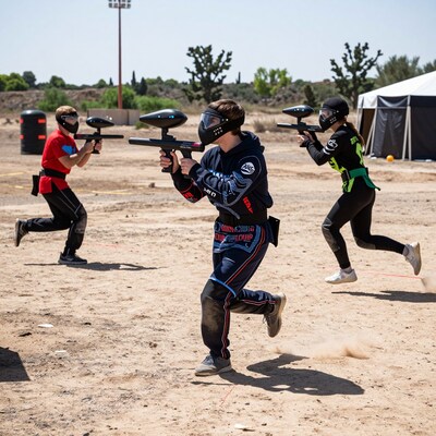 Paintball players running and shooting